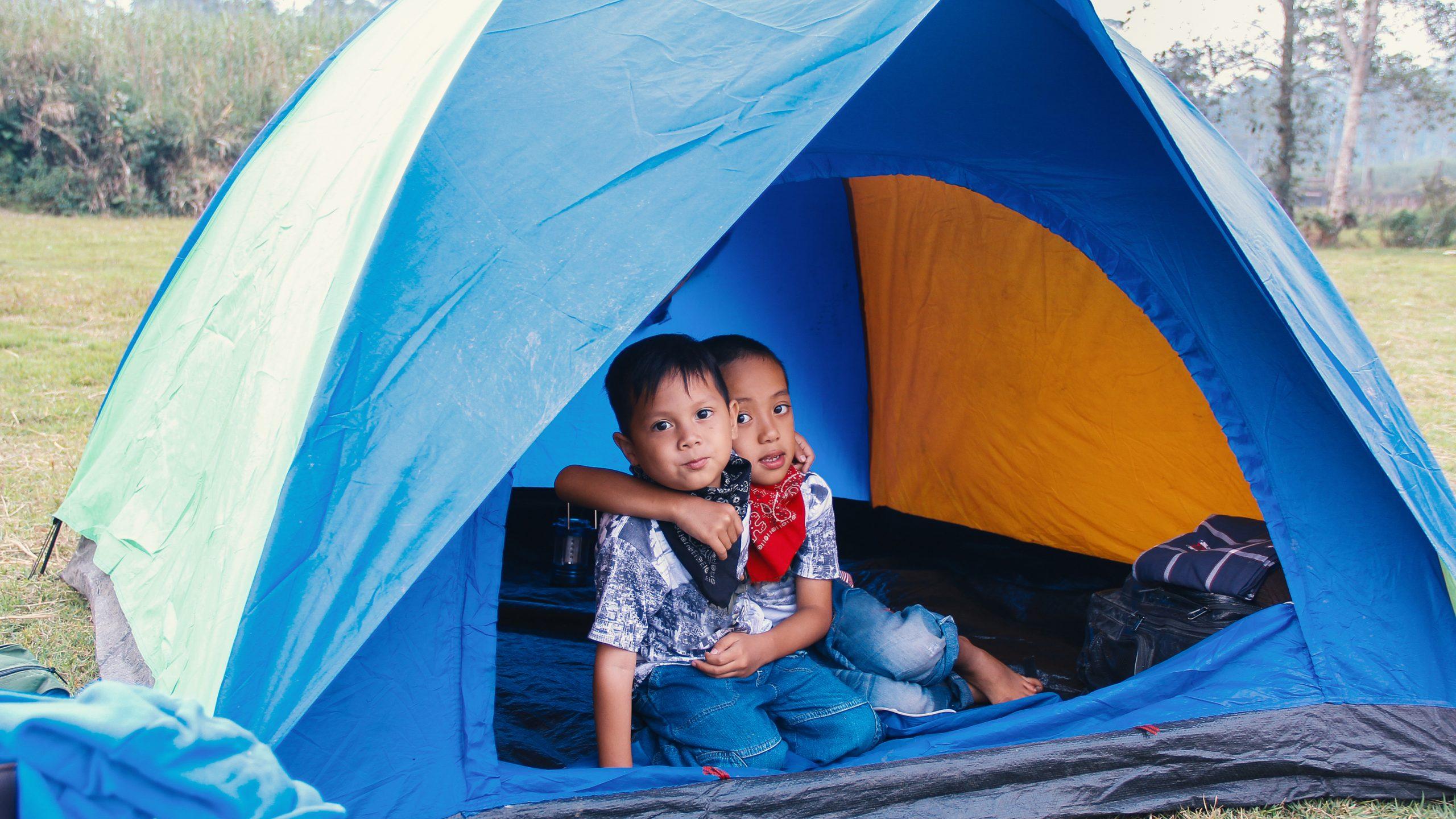 two-happy-boys-kids-inside-the-tent-hugging-each-other-asian-kids-camping-ground-scene